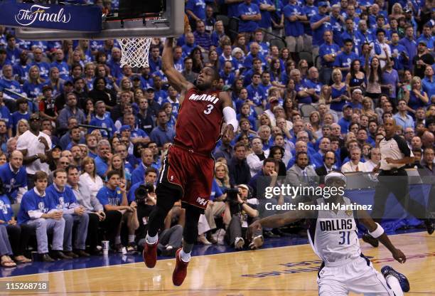 Dwyane Wade of the Miami Heat dunks against Jason Terry of the Dallas Mavericks in Game Three of the 2011 NBA Finals at American Airlines Center on...