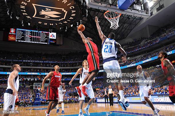 LeBron James of the Miami Heat dunks against Ian Mahinmi of the Dallas Mavericks during Game Three of the 2011 NBA Finals on June 5, 2011 at the...