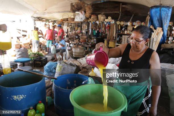 People working in the sale of Tucupi liquid made from mashed cassava vegetal for sale at the most fascinating river market from 1625 called...