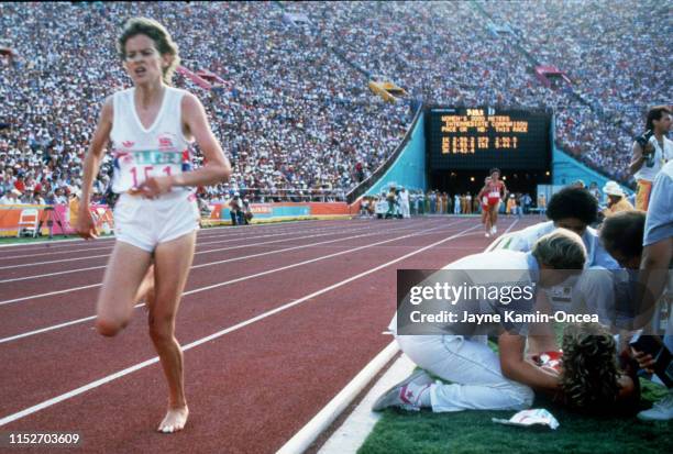 Mary Decker is attended to on track as Zola Budd went on to finish seventh in the women's 3000-meter race final during the 1984 Olympics at the...