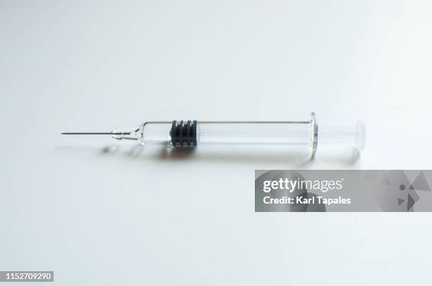 a glass medical syringe on a white background - portrait studio shot stock pictures, royalty-free photos & images