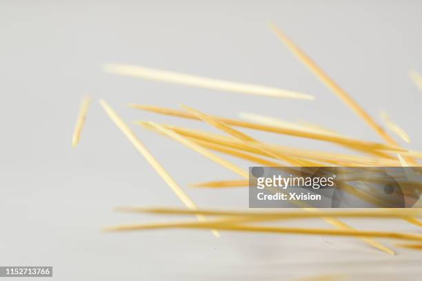 toothpick dancing on white background captured with high speed sync. - toothpick stock pictures, royalty-free photos & images