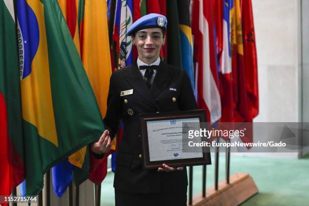 Portrait of Lieutenant Commander Marcia Andrade Braga holding Gender Advocate of the Year Award, Brazilian naval officer serving with the UN...