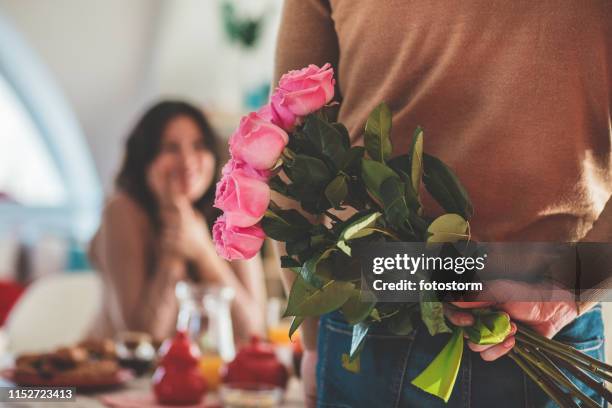 bouquet of roses as a surprise - man giving flowers stock pictures, royalty-free photos & images