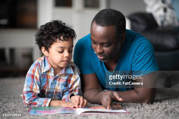 father reading to son - reading stock pictures, royalty-free photos & images