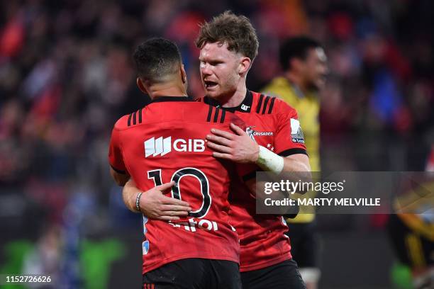 Crusaders' Richie Mo'unga and teammate Mitchell Drummond celebrate their win in the Super Rugby semi-final match between New Zealand's Crusaders and...