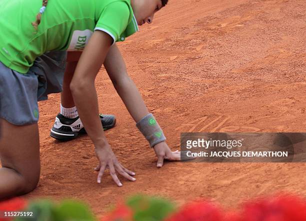 Ball girl wrote 'Go Roger' as Switzerland's Roger Federer plays with Spain's Rafael Nadal during their Men's final match in the French Open tennis...