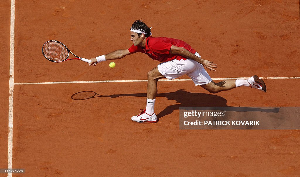 Switzerland's Roger Federer returns the