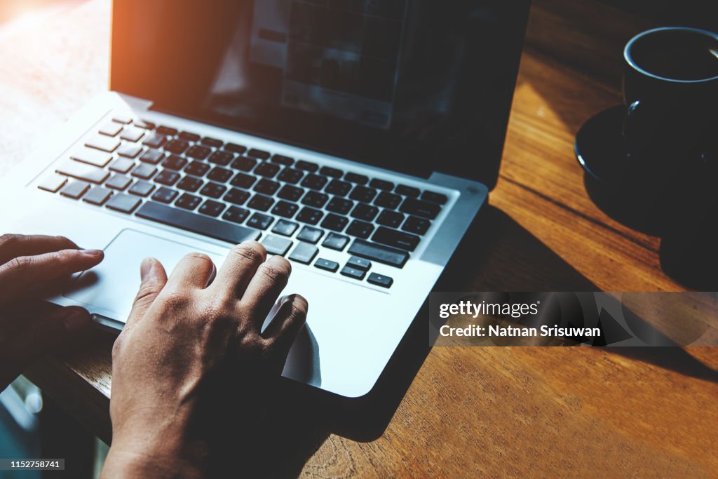 Man's hands using laptop.