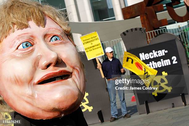 Anti-nuclear protesters display an effigy of Angela Merkel outside the Chancellery shortly before the weekly German government cabinet meeting on...