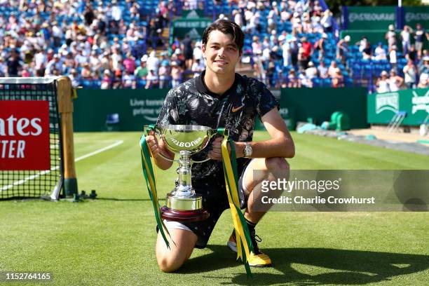 Taylor Fritz of USA celebrates with the cup after winning the men's singles final against Sam Querrey of USA during day six of the Nature Valley...