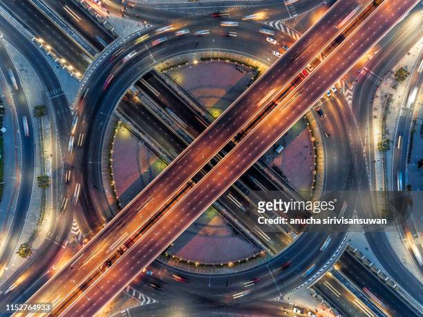 aerial view, expressway road intersection, traffic in bangkok at night, thailand. - traffic circle stock pictures, royalty-free photos & images