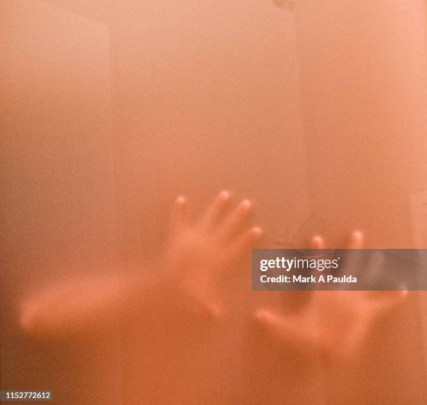 two hands pressed against frosted glass - pushing stock pictures, royalty-free photos & images