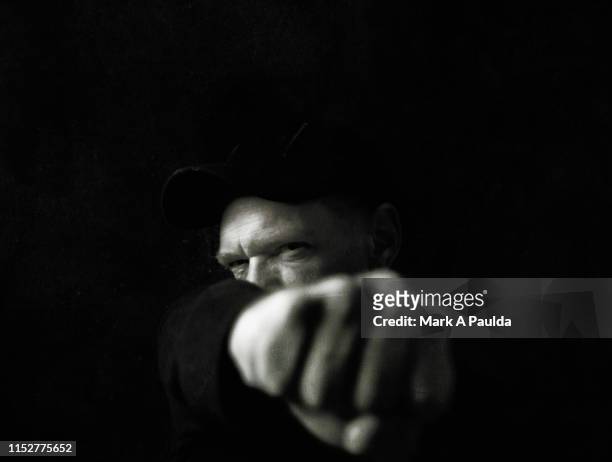 man punching his fist into the foreground - punching stock pictures, royalty-free photos & images
