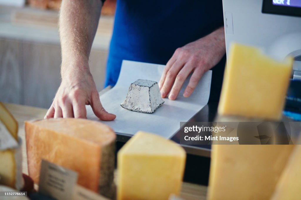 Cheeseseller wrapping up goats cheese