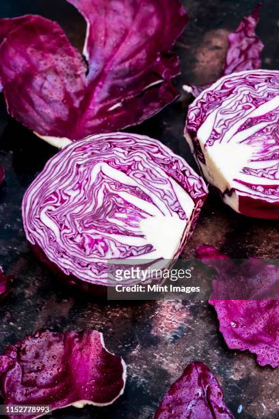 a raw round red cabbage, cut across the middle. - cut cabbage stock pictures, royalty-free photos & images