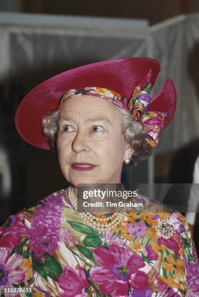 Queen Elizabeth II, wearing a brightly coloured floral print hat and dress, during a visit to Cyprus, 21 October 1993. The Queen is on an official...