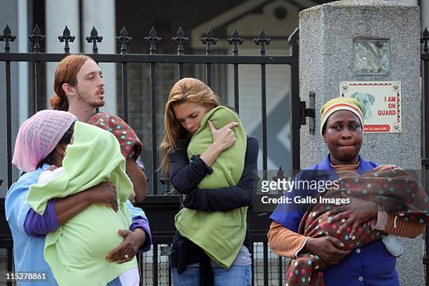 Lady Victoria spencer, ex-wife to Earl Charles Spencer cuddles a baby next to Deam Berger and nursing staff outside the Building Blocks temporary...