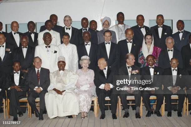 Queen Elizabeth II and Prince Philip sitting either side of the President of Cyprus, Glafcos Clerides, as they pose with various Commonwealth heads...