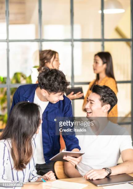 colleagues having a conversation. - east asian ethnicity stock pictures, royalty-free photos & images
