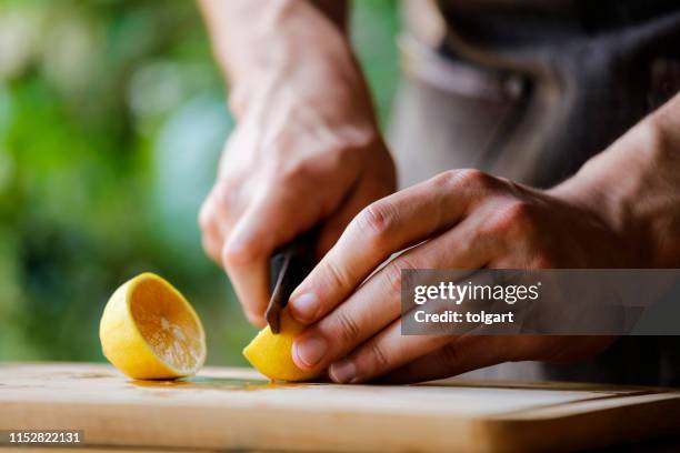 barista cutting lemon - lemon juice stock pictures, royalty-free photos & images