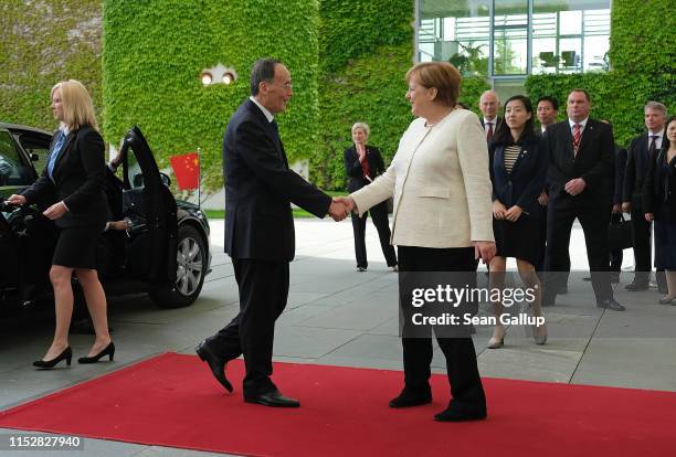 German Chancellor Angela Merkel greets Chinese Vice President Wang Qishan upon his arrival at the Chancellery on May 31, 2019 in Berlin, Germany. The...