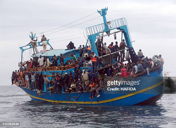 African migrants stranded on a boat coming from Libya wait for rescue services, near Sfax, on the Tunisian coast, on June 4, 2011. Between 200 and...
