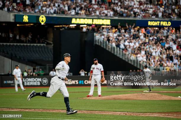 Aaron Judge of the New York Yankees rounds the bases after hitting a home run during the fifth inning of game one of the 2019 Major League Baseball...