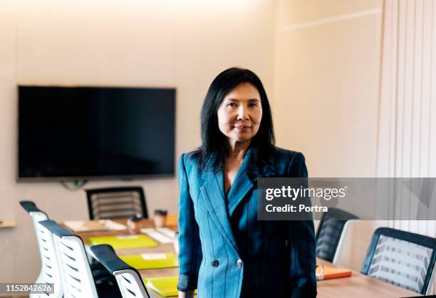 portrait of well-dressed senior businesswoman - taiwan business stock pictures, royalty-free photos & images