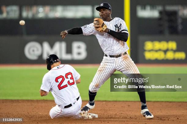 Didi Gregorius of the New York Yankees turns a double play over Michael Chavis of the Boston Red Sox during the eighth inning of game one of the 2019...