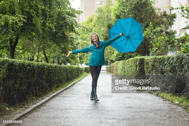 dancing in the rain - dancing in the rain stock pictures, royalty-free photos & images