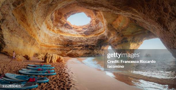 benagil cave, algarve, portugal. sup boards and beach - portugal coast stock pictures, royalty-free photos & images