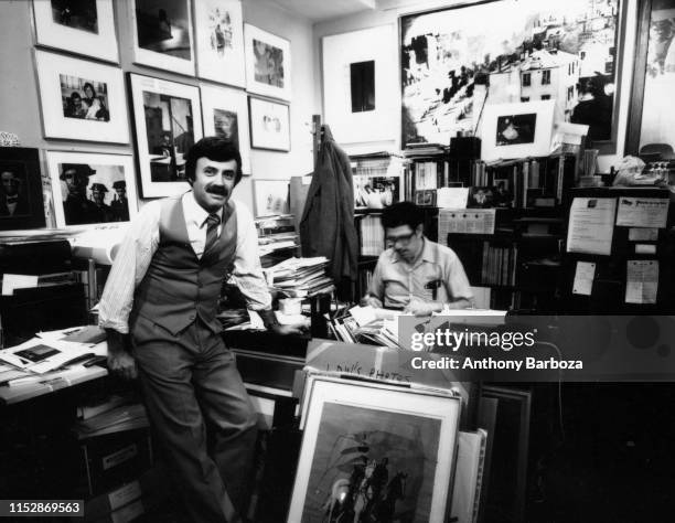 Portrait of art dealer and gallery owner Lee Witkin as he stands in his office at the Witkin Gallery, New York, New York, 1978. The man at right is...