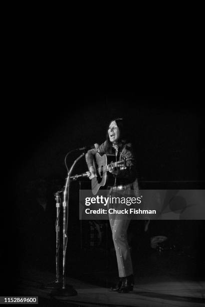 American folk musician Buffy Sainte-Marie plays guitar as she performs onstage during a concert at the Northern Illinois University fieldhouse,...