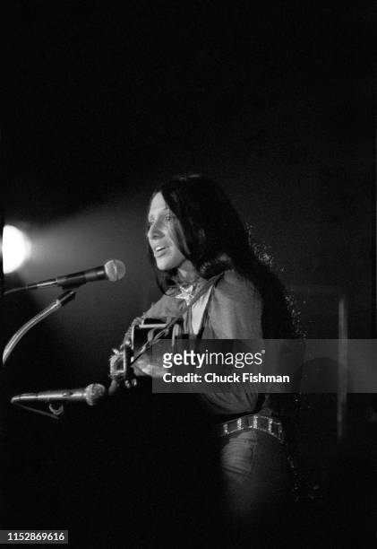 American folk musician Buffy Sainte-Marie plays guitar as she performs onstage during a concert at the Northern Illinois University fieldhouse,...