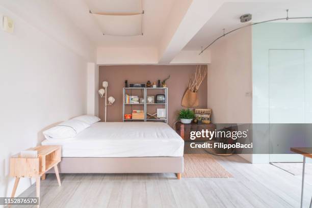 open space interior with a bedroom corner - studio apartment stock pictures, royalty-free photos & images