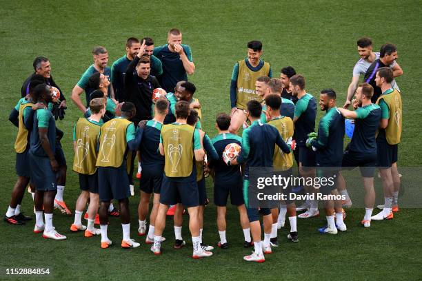 Mauricio Pochettino, Manager of Tottenham Hotspur jokes with players during the Tottenham Hotspur training session on the eve of the UEFA Champions...