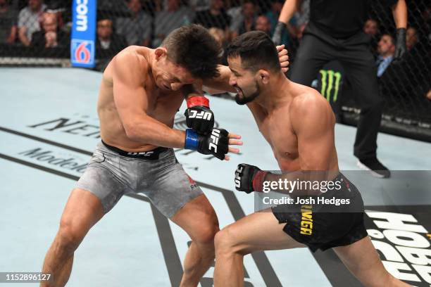 Jussier Formiga of Brazil elbows Joseph Benavidez in their flyweight bout during the UFC Fight Night event at the Target Center on June 29, 2019 in...