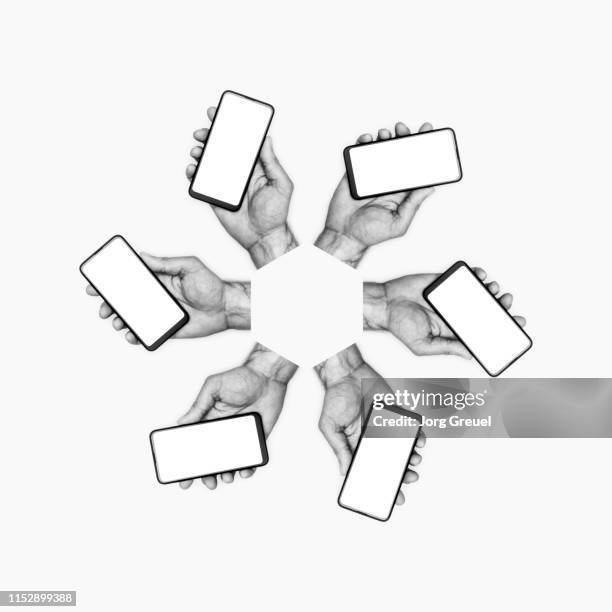 hands holding smartphones - black and white objects stock pictures, royalty-free photos & images