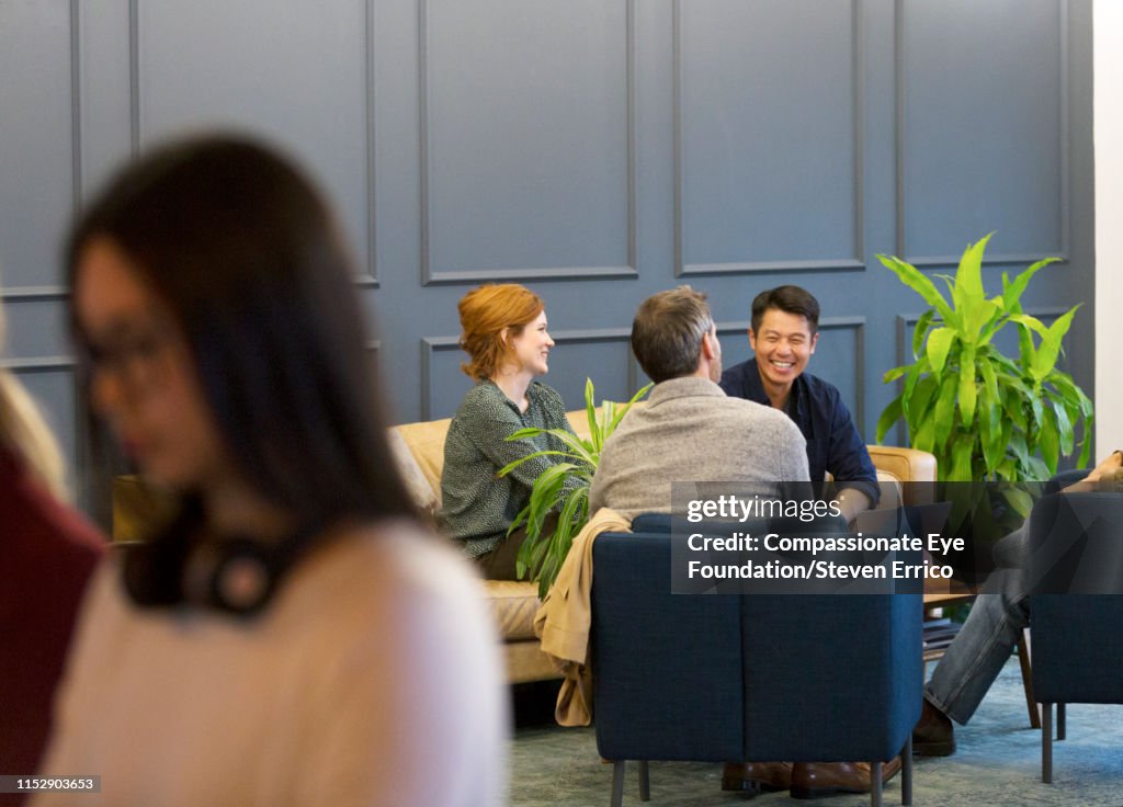 Creative business people having meeting in modern open plan office