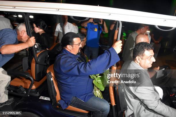 Hollywood actor Steven Seagal and his wife Erdenetuya Seagal are on their way to a private village by a caddie cart following their arrival on an...