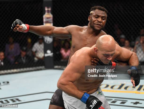 Francis Ngannou of Cameroon punches Junior Dos Santos of Brazil in their heavyweight bout during the UFC Fight Night event at the Target Center on...