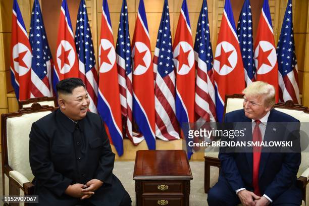 North Korea's leader Kim Jong Un and US President Donald Trump attend a meeting on the south side of the Military Demarcation Line that divides North...