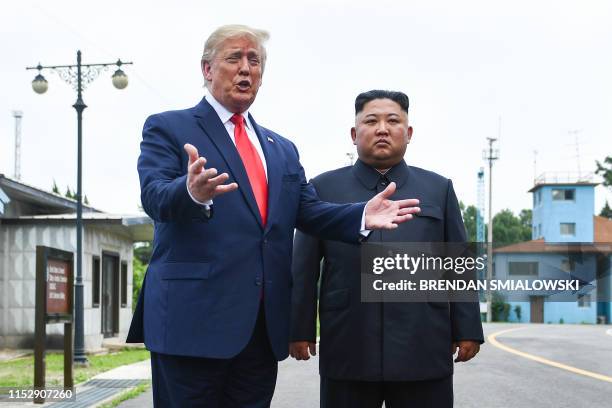 President Donald Trump speaks as he stands with North Korea's leader Kim Jong Un south of the Military Demarcation Line that divides North and South...