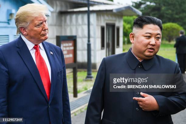 North Korea's leader Kim Jong Un speaks as he stands with US President Donald Trump south of the Military Demarcation Line that divides North and...