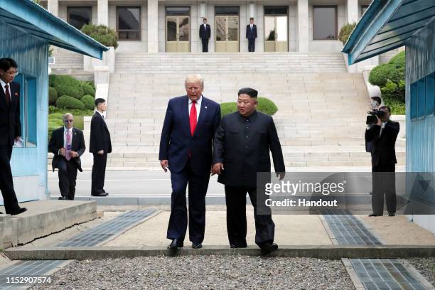 Handout photo provided by Dong-A Ilbo of North Korean leader Kim Jong Un and U.S. President Donald Trump inside the demilitarized zone separating the...