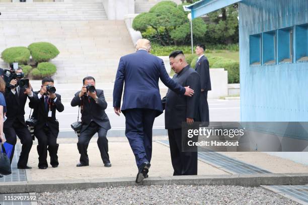 Handout photo provided by Dong-A Ilbo of North Korean leader Kim Jong Un and U.S. President Donald Trump inside the demilitarized zone separating the...