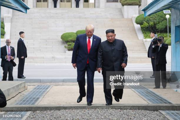 Handout photo provided by Dong-A Ilbo of North Korean leader Kim Jong Un and U.S. President Donald Trump inside the demilitarized zone separating the...