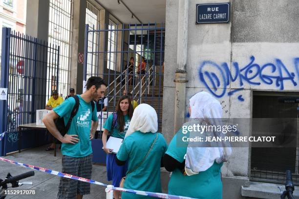 Members of the "Alliance Citoyenne" association gather in front of the Jean Bron municipal swimming pool in Grenoble, central-eastern France, after...
