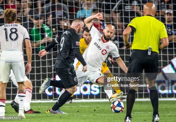 Toronto FC defender Laurent Ciman defends against D.C. United forward Wayne Rooney during a MLS match between D.C United and Toronto FC on June 29 at...